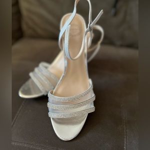 Size 8.5 Silver mesh/strappy dress shoe with solid wedge heel. Worn once.